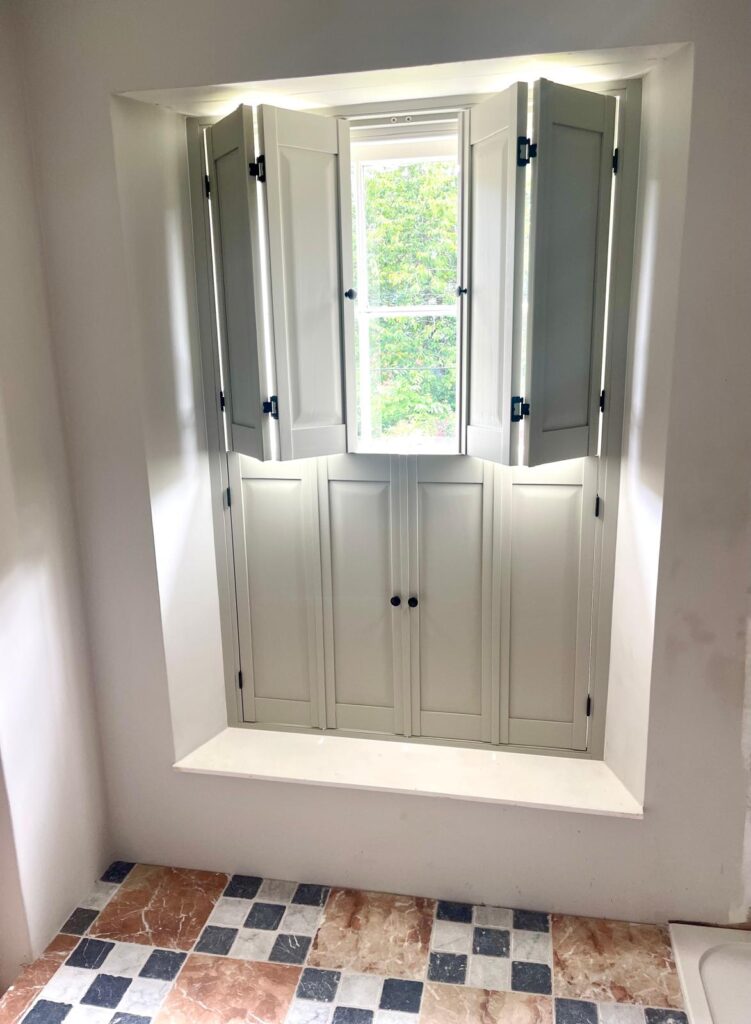 Tier on tier solid panel shutters on sash bay window